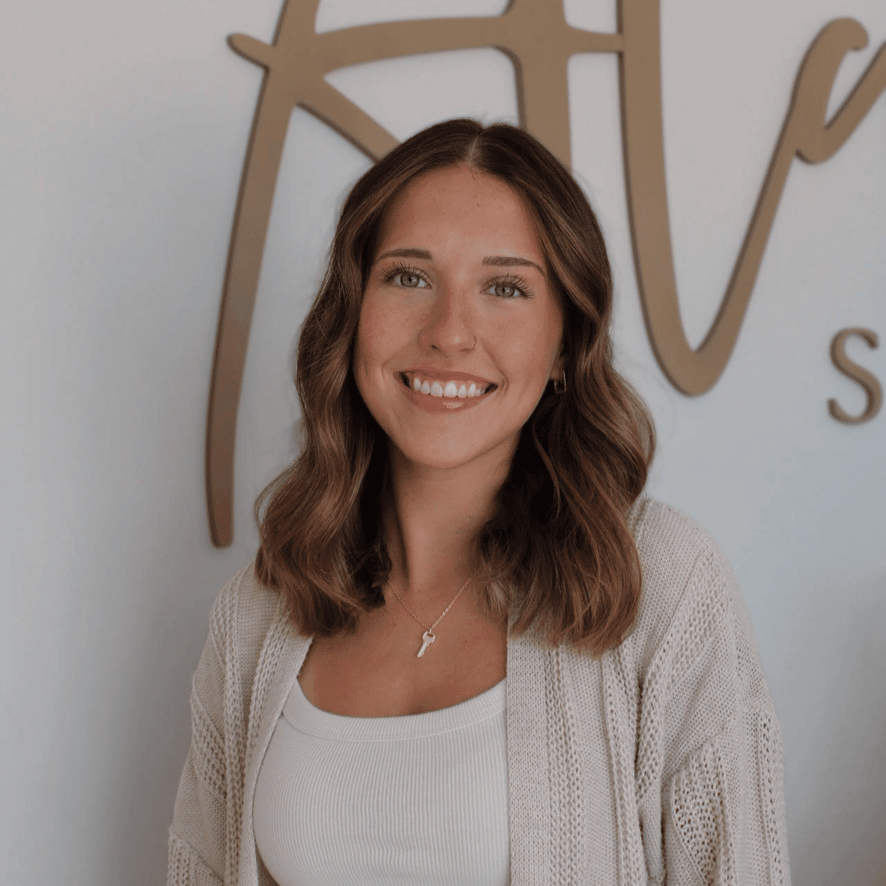 Portrait of Gracelyn, a professional stylist at Alana Kai Salon, showcasing their expertise and style.