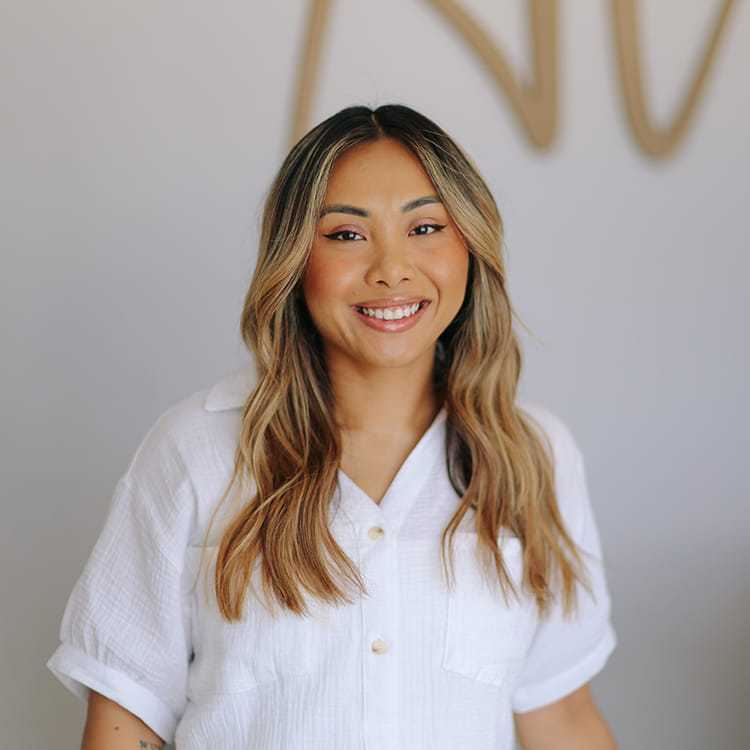 Portrait of Christy So, a professional stylist at Alana Kai Salon, showcasing their expertise and style.