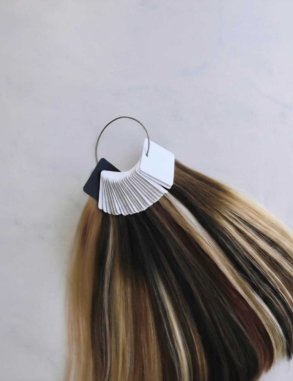Hair color swatches on a keyring showing various shades from blonde to dark brown.